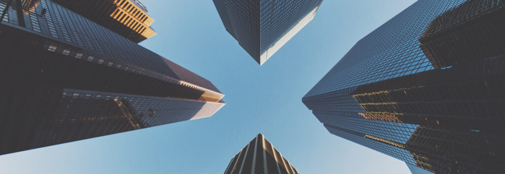 Worm's-eye view of four skyscrapers.