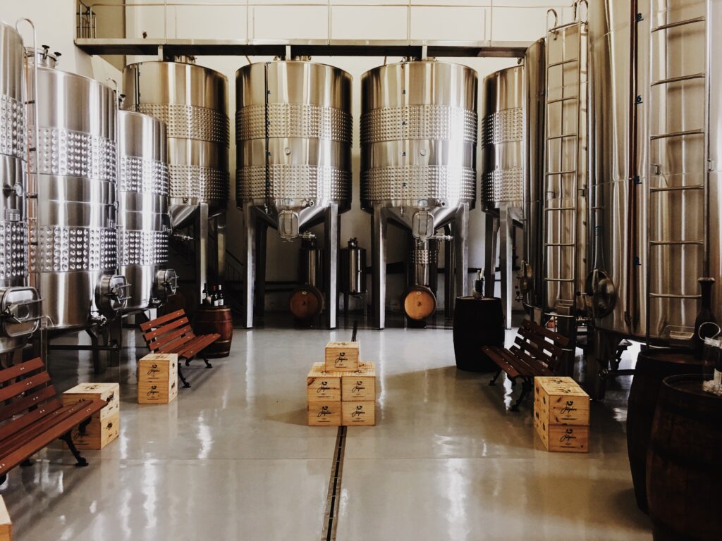 A room full of silver Conical-Bottom Fermenters.