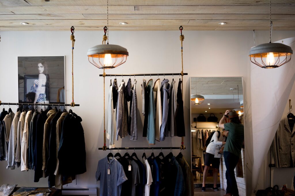 Racks of shirts in a storefront.