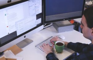 An individual working at a desktop computer.