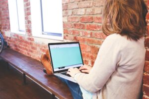 A woman working at a laptop.