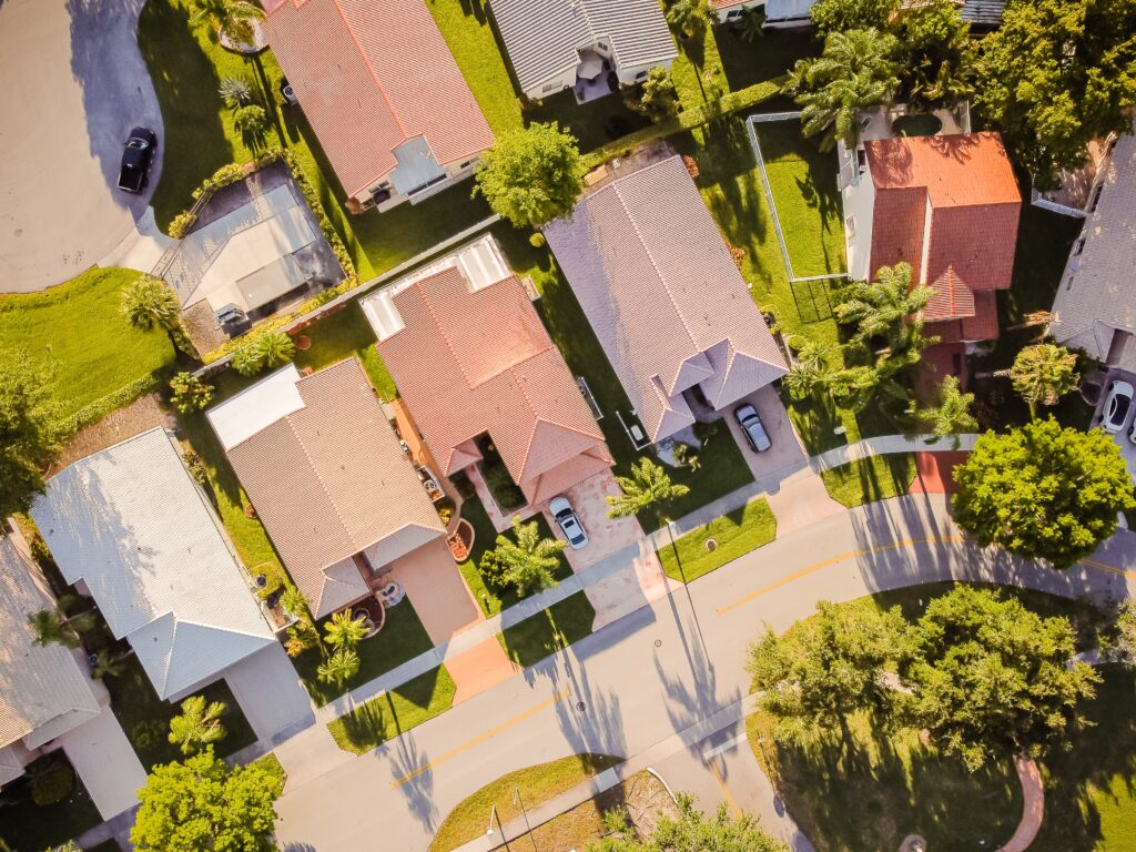 aerial shot of a suburban neighborhood of mid-sized houses.