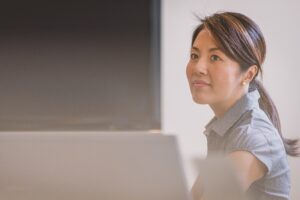 A woman sitting in an office.