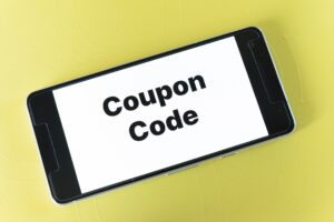 The words "coupon code" on the screen of a smartphone.