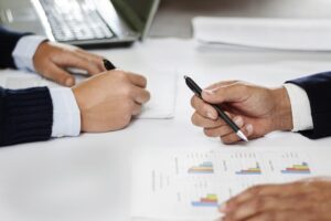 Two people sitting at a desk.