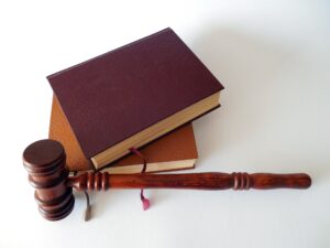 Two leather bound books and a gavel.