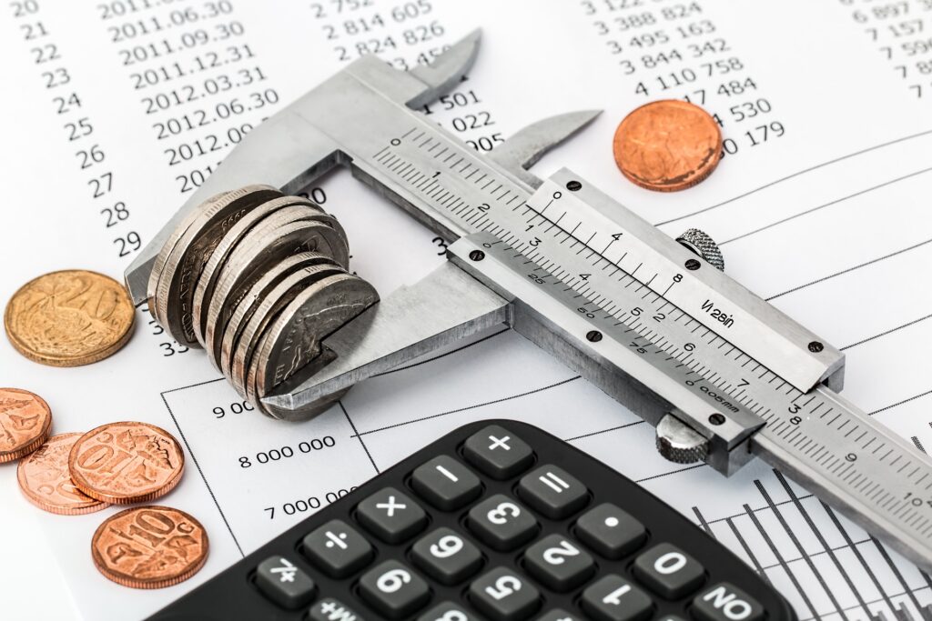 A stack of coins being measured with a clamp.