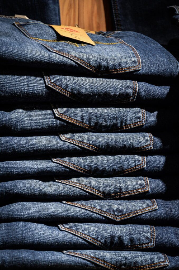 A pile of folded up blue jean pants.