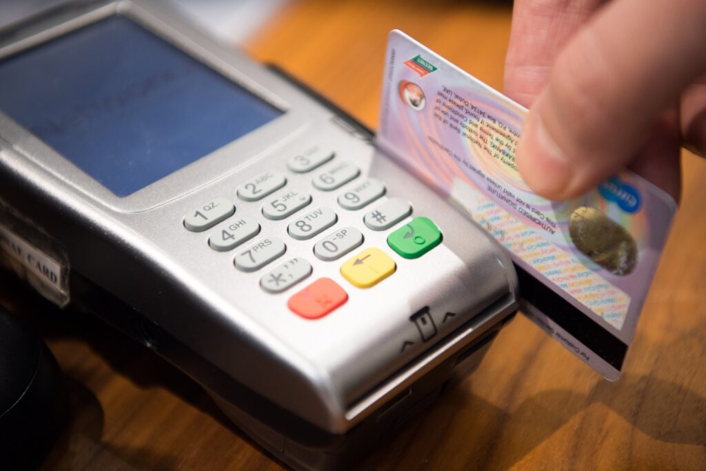 A credit card being swiped in a card reader.