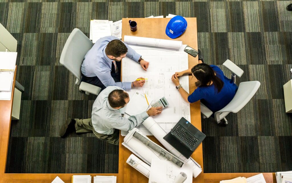 A group of 3 people meeting together.