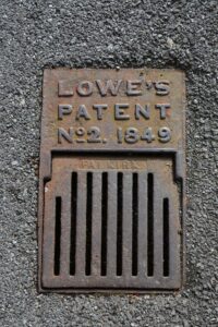 A street drain that says "Lowe's patent".