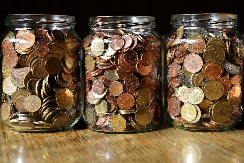 Three jars full of coins.