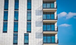 The side view of a white building with windows.